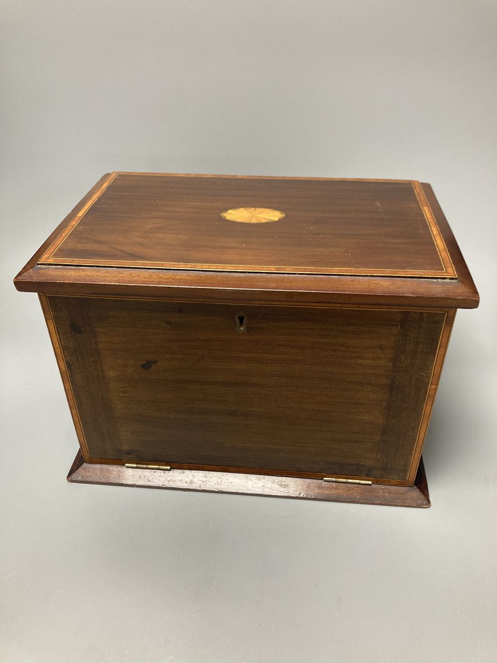 An Edwardian inlaid mahogany writing box, with hinged folding slope and fittings, 29cm, and a Victorian walnut and parquetry tea caddy,